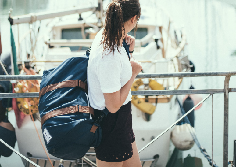 women looking at a boat in the water